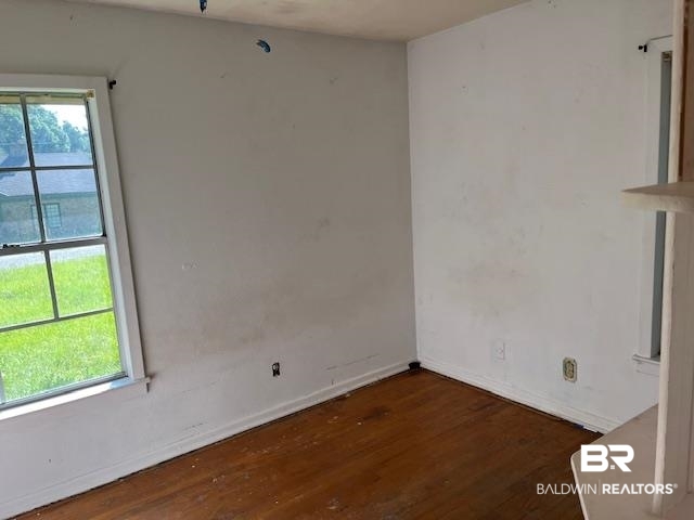103 Briarcliff Road Brewton, AL 36426 - Photo 6 of 7 Empty room featuring hardwood / wood-style flooring and a healthy amount of sunlight