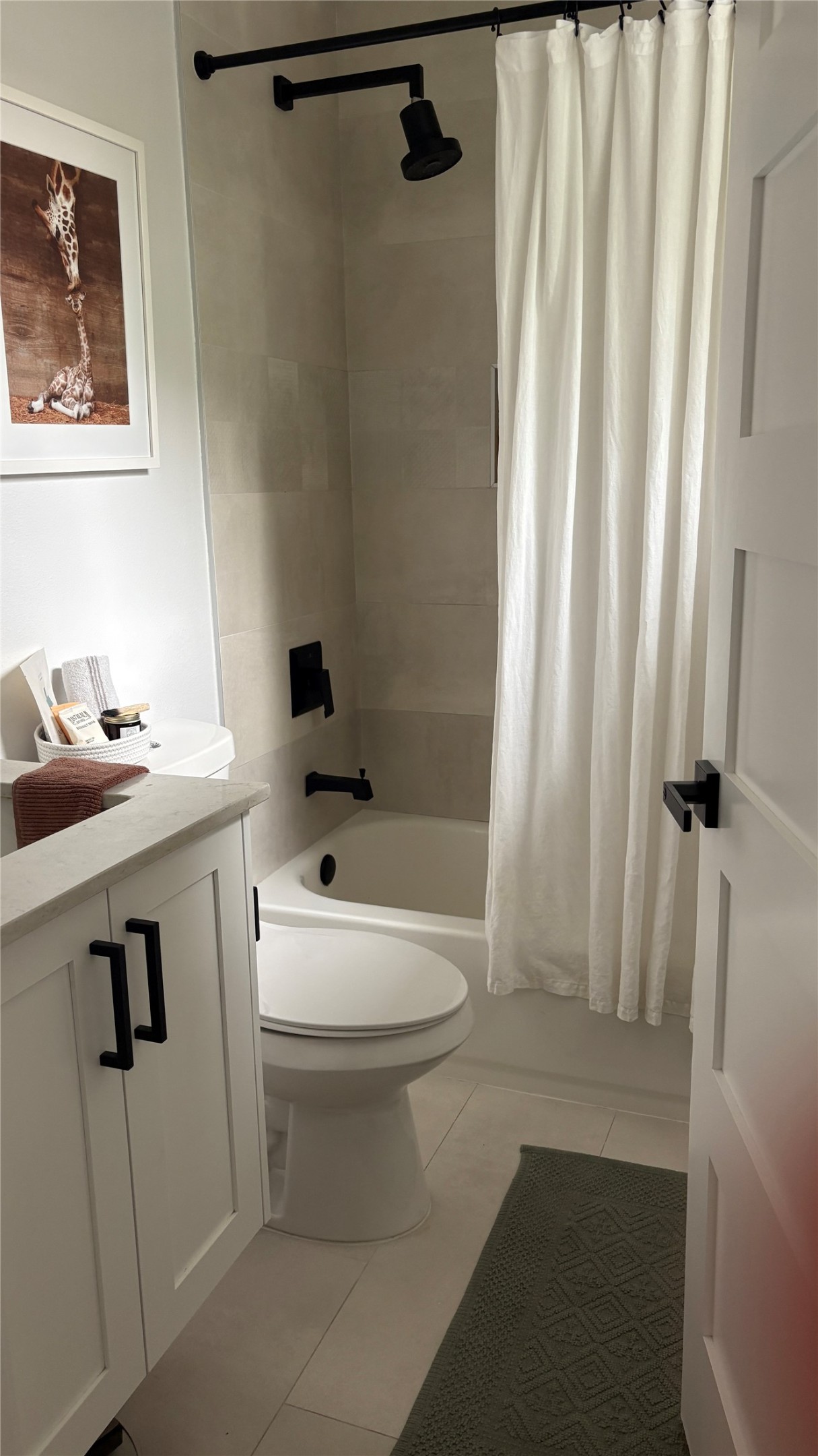 1816 Adina Street, Unit 2 Austin, TX 78721 - Photo 20 of 25 Bathroom featuring a white vanity with black hardware, a light-toned countertop, and a white toilet
