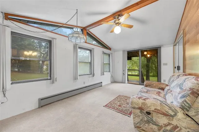 a view of a bedroom with wooden floor and windows