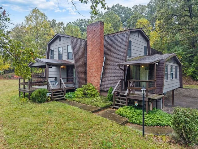 a view of a house with a yard and deck