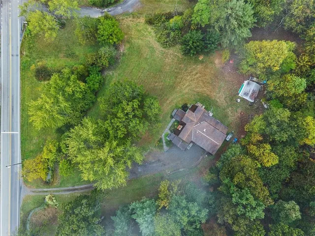 an aerial view of a house with a yard