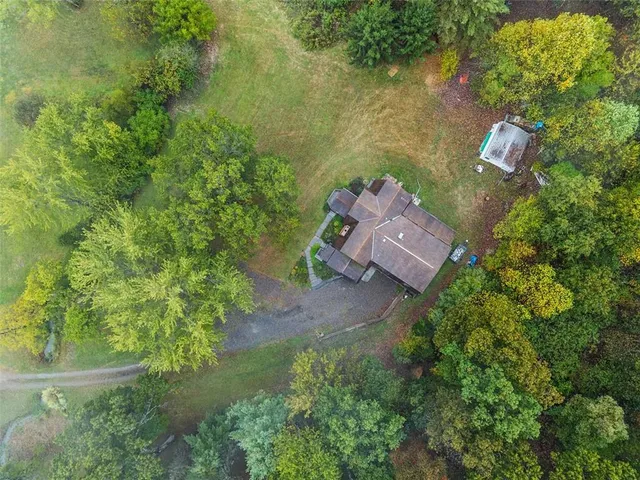 an aerial view of a house with a yard