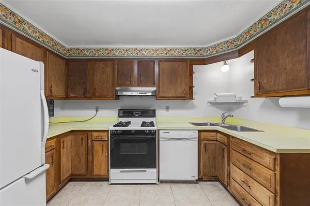 a kitchen with a stove sink and cabinets