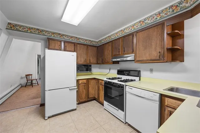 a kitchen with a refrigerator sink and cabinets