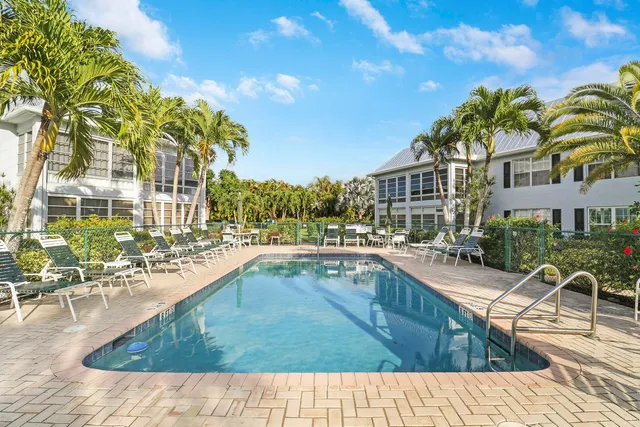 a view of swimming pool with outdoor seating and plants