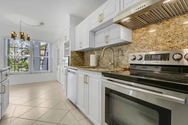 a kitchen with stainless steel appliances granite countertop a stove and a sink
