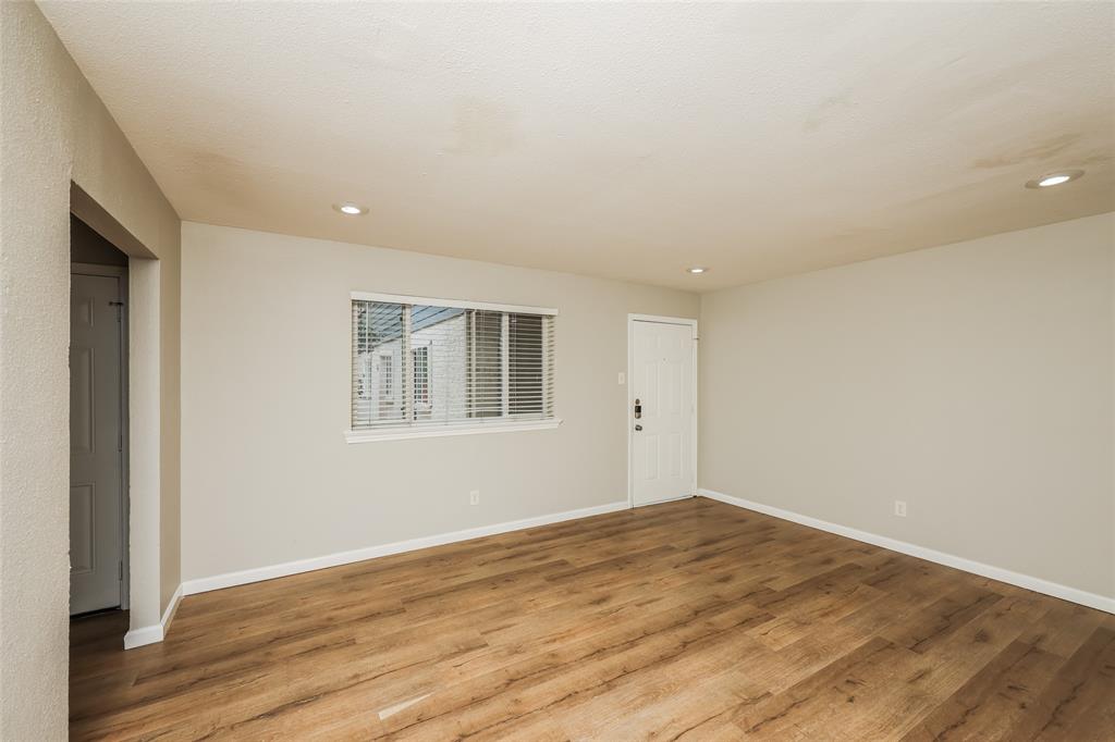 4618 Reiger Avenue, Unit 104 Dallas, TX 75246 - Photo 6 of 19 a view of empty room with wooden floor and fan