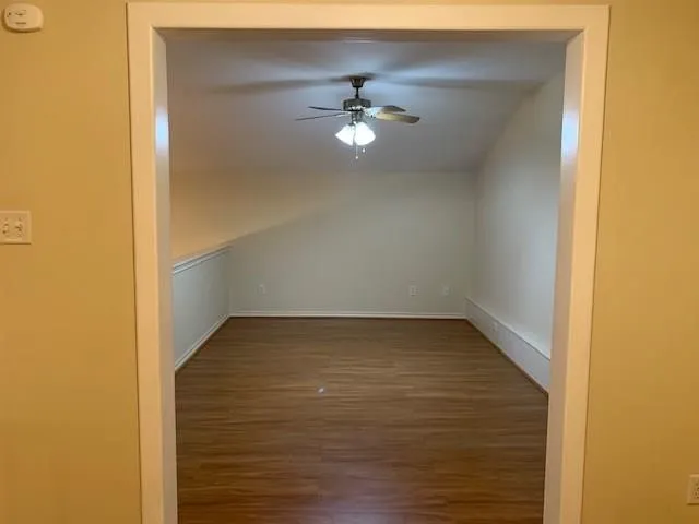 a view of a room with wooden floor