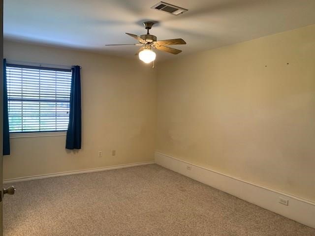 1922 20th Street Huntsville, TX 77340 - Photo 17 of 49 an empty room with windows and fan
