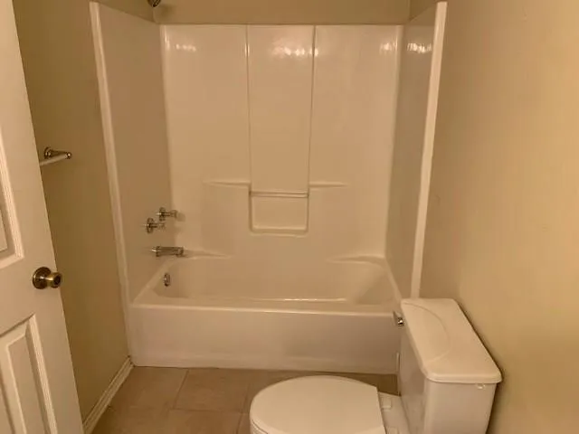 a bathroom with a toilet and a bath tub