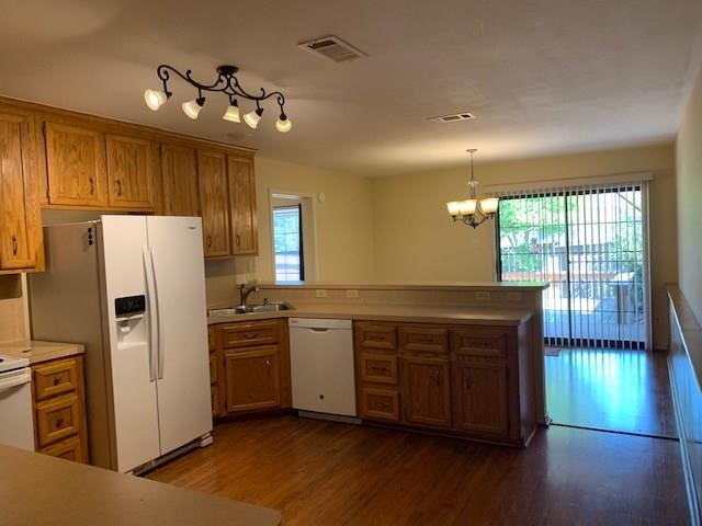 1922 20th Street Huntsville, TX 77340 - Photo 29 of 49 a kitchen with stainless steel appliances granite countertop a refrigerator a sink dishwasher a stove and a large window with wooden floor