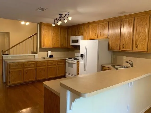 a kitchen with stainless steel appliances a refrigerator sink and cabinets