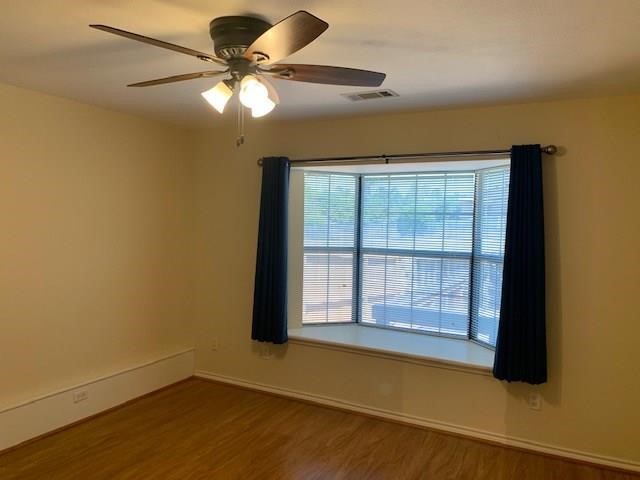 1922 20th Street Huntsville, TX 77340 - Photo 37 of 49 a view of an empty room with a window and wooden floor