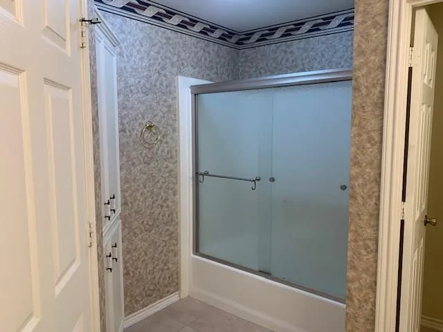 a bathroom with a glass door shower