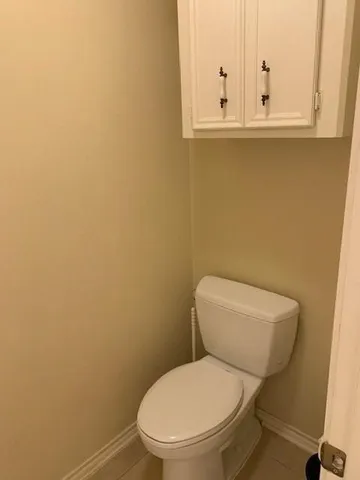 a white toilet sitting next to a sink