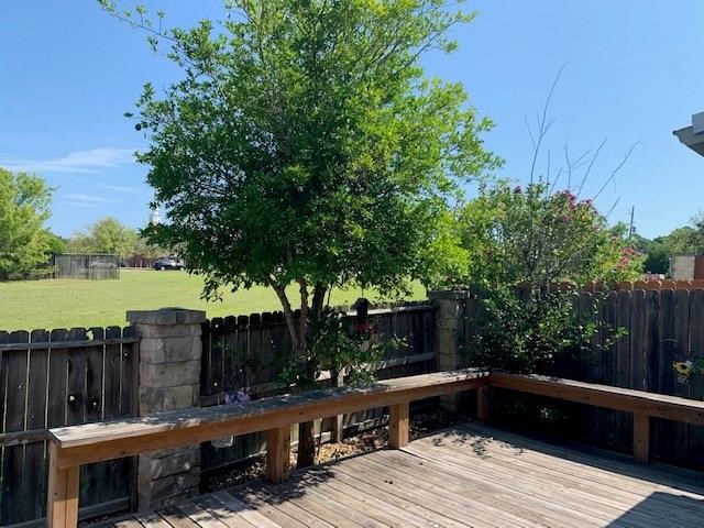 1922 20th Street Huntsville, TX 77340 - Photo 47 of 49 a view of a backyard with wooden floor and fence