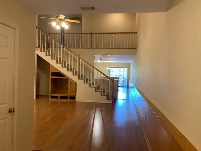 a view of entryway and hall with wooden floor