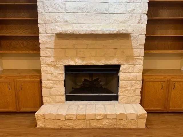 a fireplace with a vase