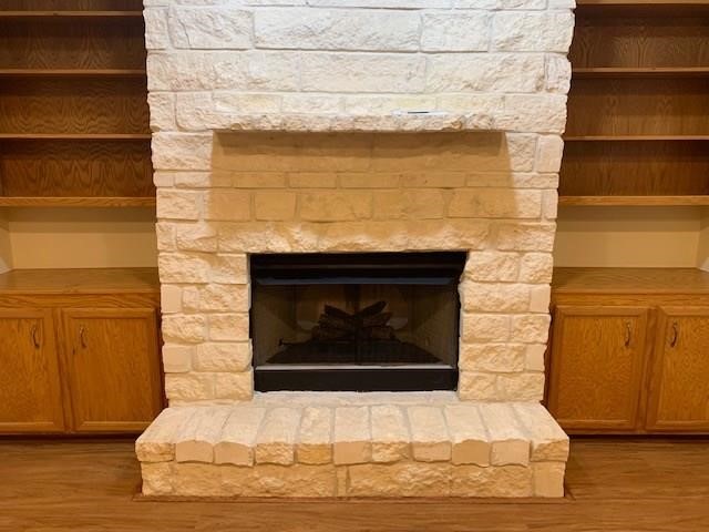 1922 20th Street Huntsville, TX 77340 - Photo 7 of 49 a fireplace with a vase