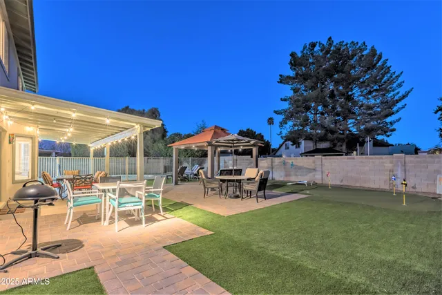 a view of a house with swimming pool yard and sitting area
