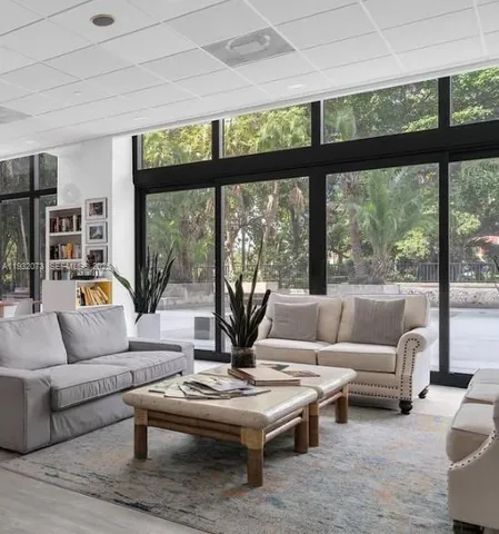 a dining room with furniture a chandelier and wooden floor