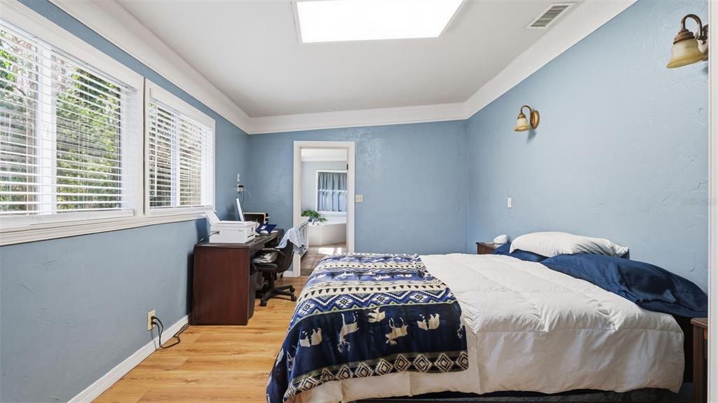 10565 Bessemer Street New Port Richey, FL 34654 - Photo 12 of 72 a bedroom with a bed and wooden floor