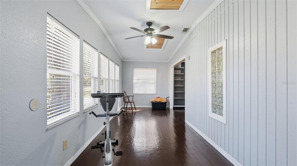 10565 Bessemer Street New Port Richey, FL 34654 - Photo 26 of 72 a view of a livingroom with furniture window wooden floor and a ceiling fan