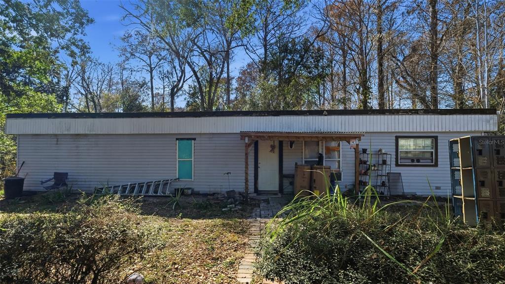 10565 Bessemer Street New Port Richey, FL 34654 - Photo 48 of 72 front view of a house with a small yard