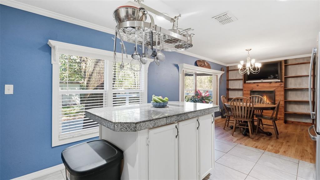 10565 Bessemer Street New Port Richey, FL 34654 - Photo 5 of 72 a dining room with furniture a chandelier and window