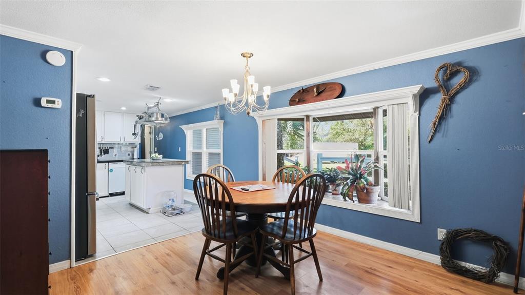 10565 Bessemer Street New Port Richey, FL 34654 - Photo 6 of 72 a view of a dining room with furniture window and wooden floor