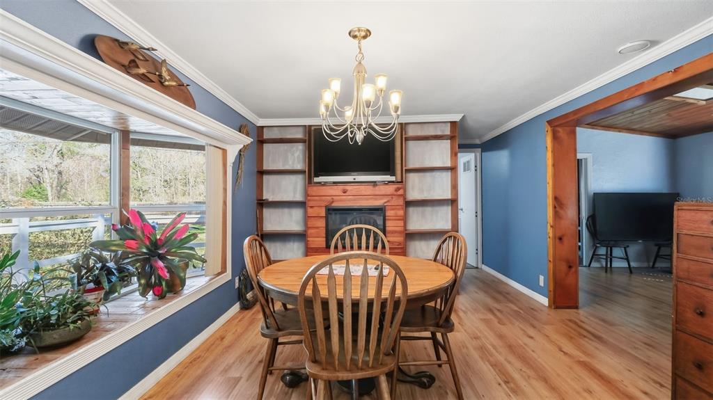 10565 Bessemer Street New Port Richey, FL 34654 - Photo 7 of 72 a view of a dining room with furniture a chandelier and wooden floor