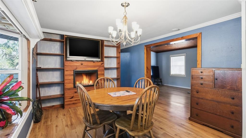 10565 Bessemer Street New Port Richey, FL 34654 - Photo 8 of 72 a view of a dining room with furniture and a chandelier
