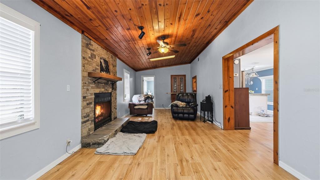 10565 Bessemer Street New Port Richey, FL 34654 - Photo 10 of 72 a living room with furniture and a fireplace