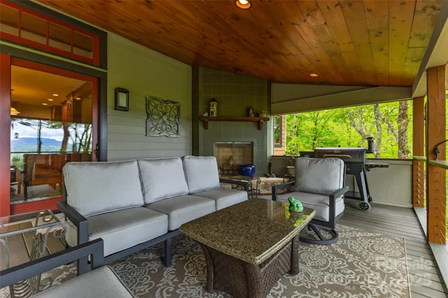 a view of balcony with wooden floor and outdoor seating