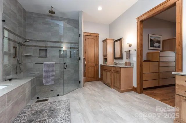 a view of walk in closet with wooden floor and windows