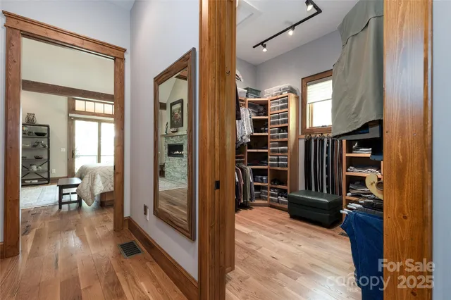 a bedroom with a bed a fireplace and dresser