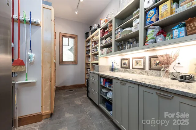 a bedroom with a bed and painting on the wall