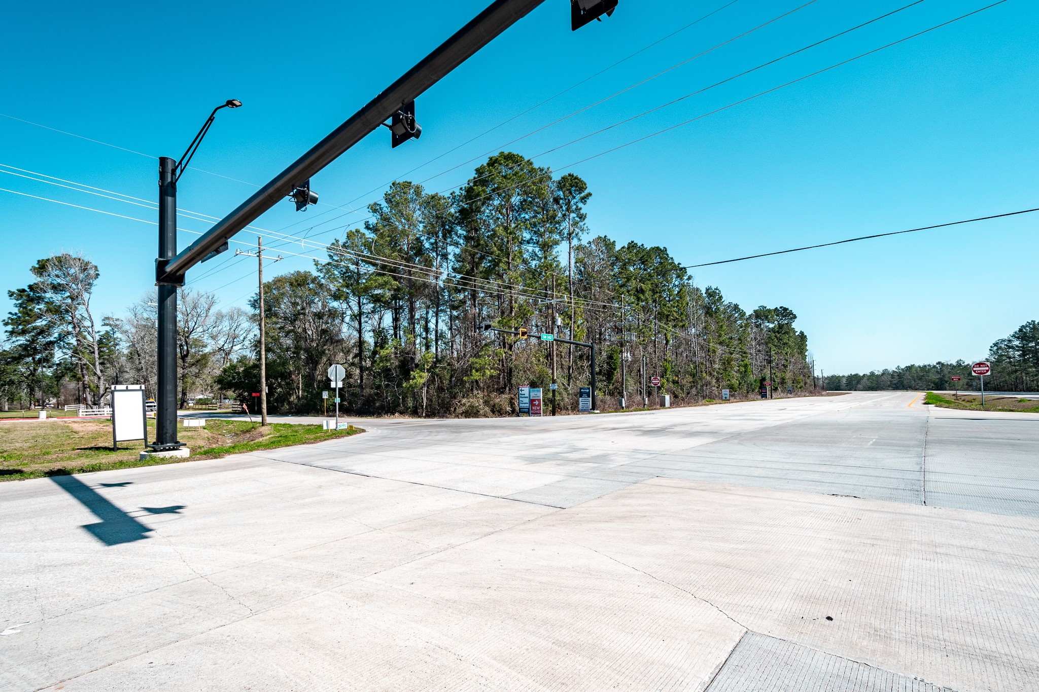 20201 Highway 242 Conroe, TX 77306 - Photo 6 of 10 a view of a swimming pool with a yard and a car park side of the road
