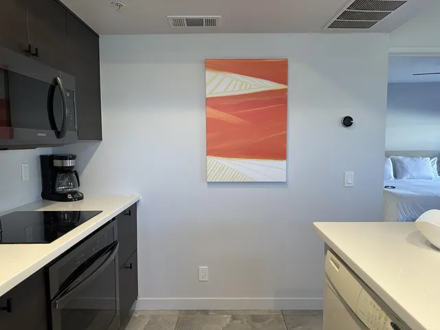 a kitchen with a sink a stove and a microwave