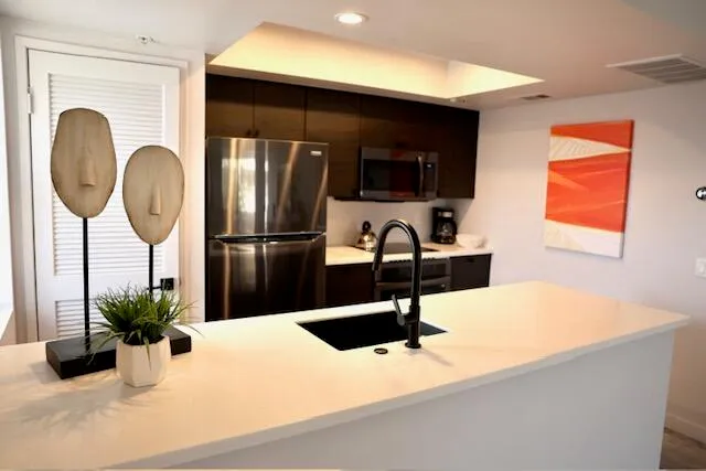 a kitchen with a refrigerator and a sink
