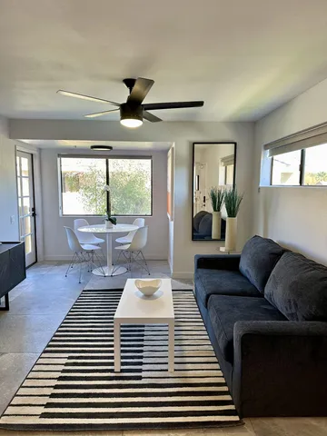 a living room with furniture and a wooden floor