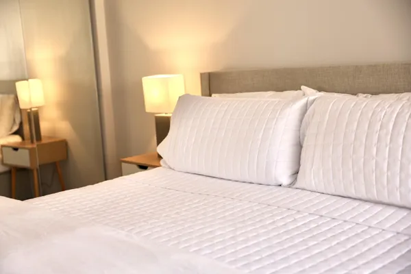 a bedroom with a bed and a night lamp