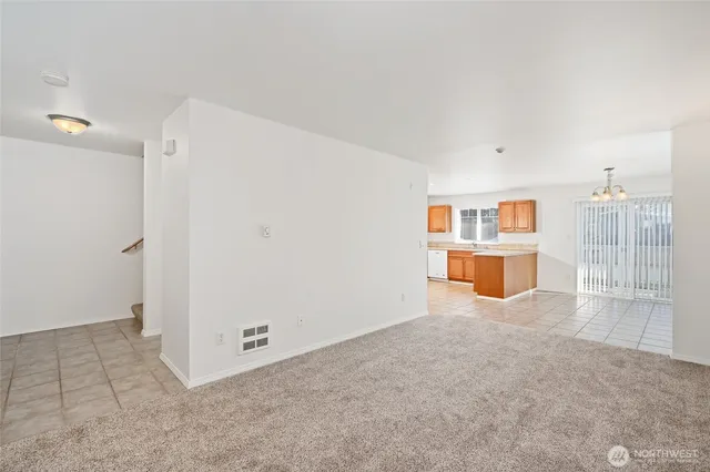 a view of kitchen with stainless steel appliances granite countertop a sink and cabinets