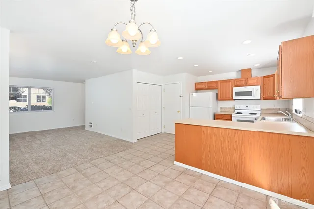 a kitchen with a sink a refrigerator a oven and cabinets