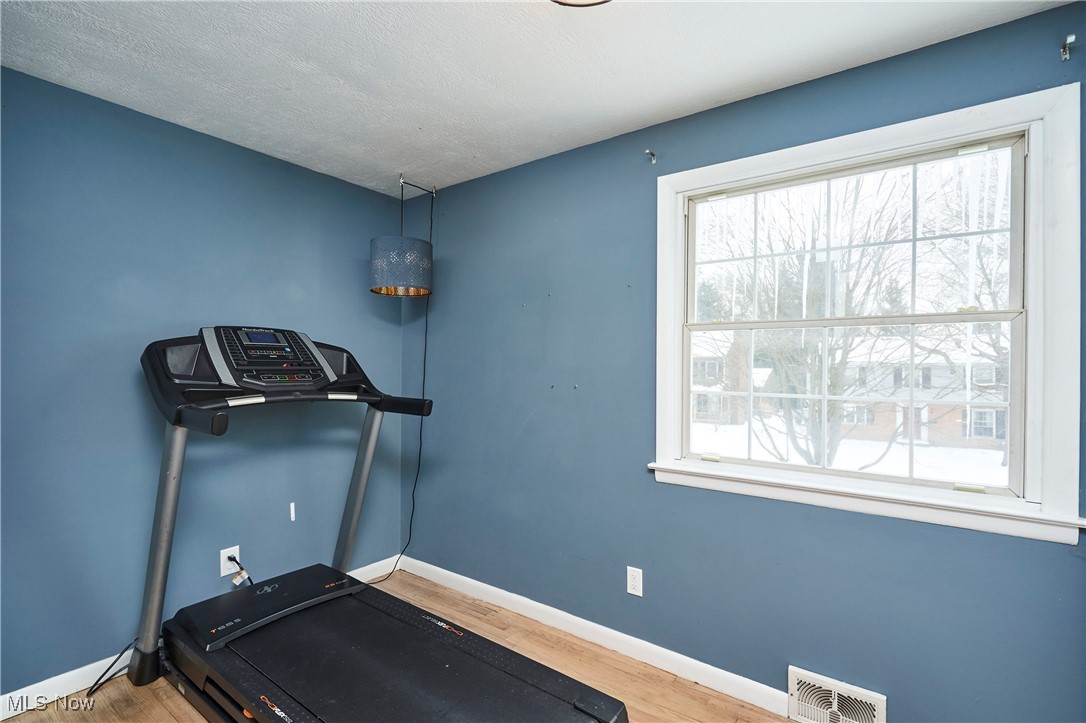 1847 Stabler Road Akron, OH 44313 - Photo 19 of 26 Workout area with plenty of natural light and wood-type flooring