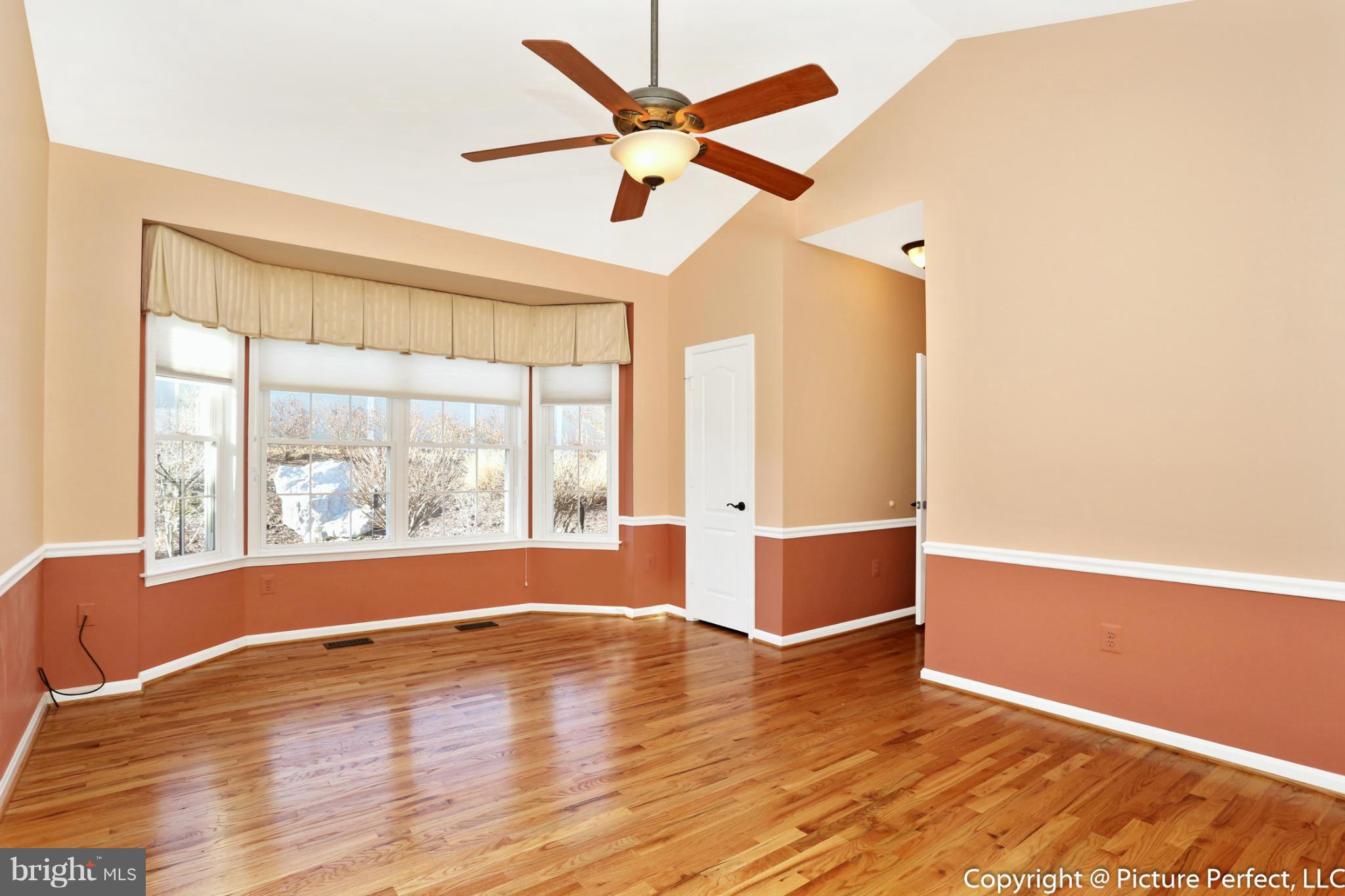 2557 Bear Den Road Frederick, MD 21701 - Photo 14 of 30 an empty room with wooden floor and windows