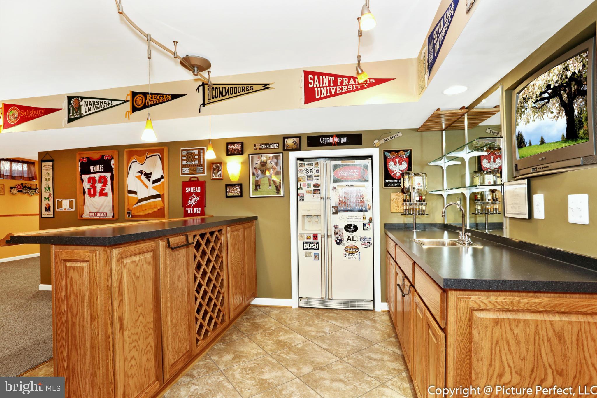 2557 Bear Den Road Frederick, MD 21701 - Photo 21 of 30 a kitchen with stainless steel appliances granite countertop a refrigerator and a sink