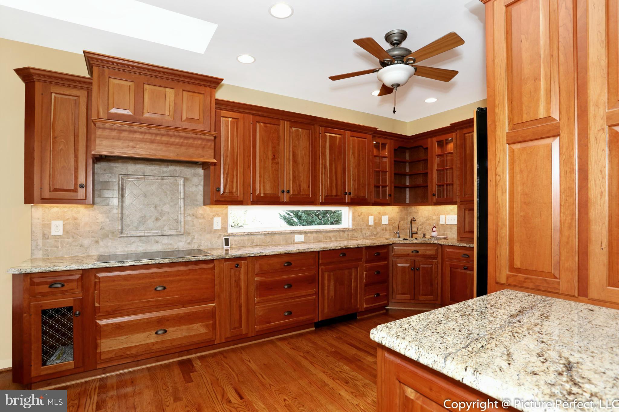 2557 Bear Den Road Frederick, MD 21701 - Photo 4 of 30 a kitchen with stainless steel appliances granite countertop cabinets and window