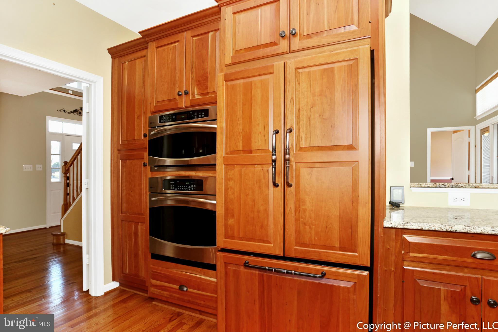2557 Bear Den Road Frederick, MD 21701 - Photo 6 of 30 a view of a kitchen with a refrigerator and wooden floor