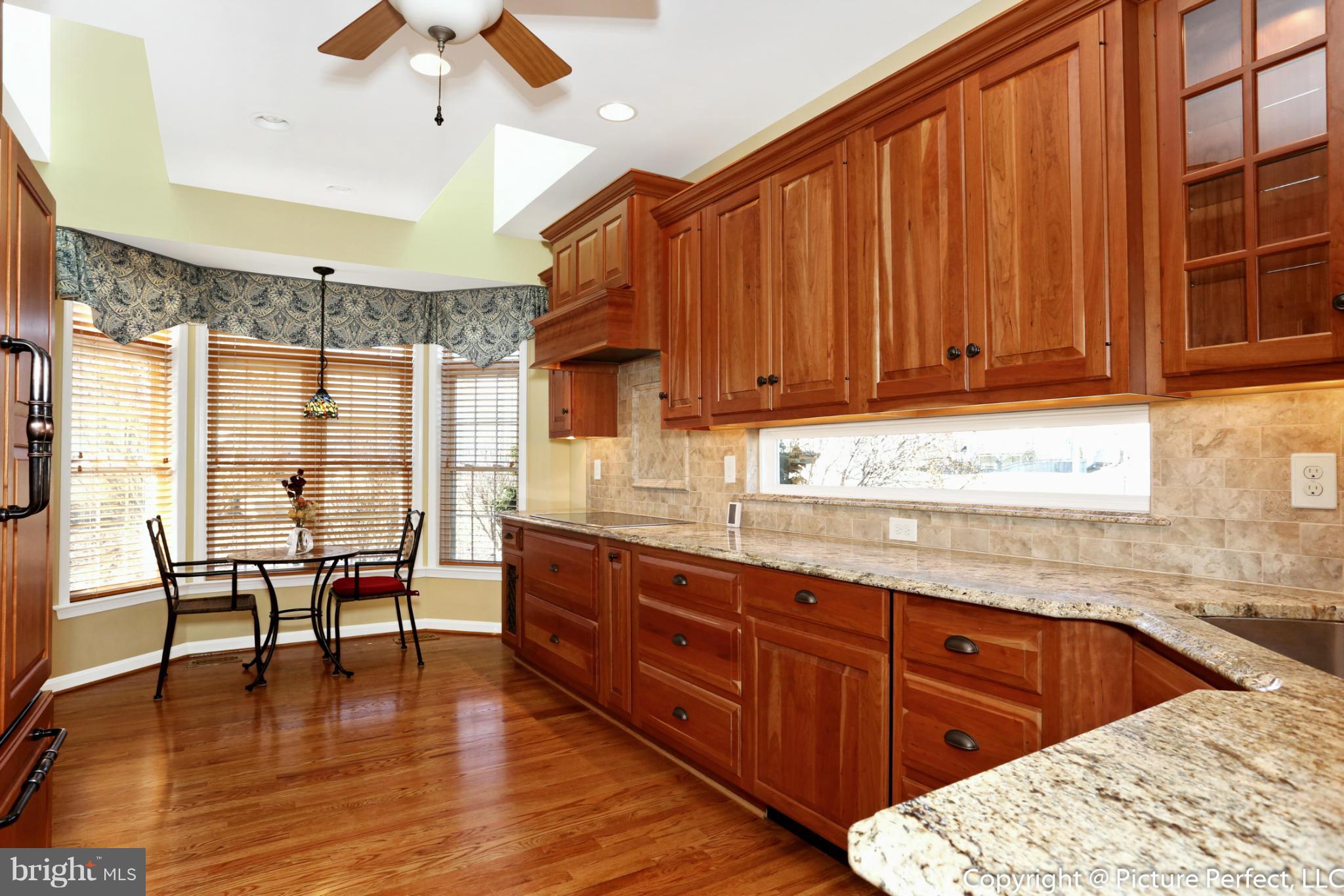 2557 Bear Den Road Frederick, MD 21701 - Photo 7 of 30 a kitchen with wooden cabinets and sink
